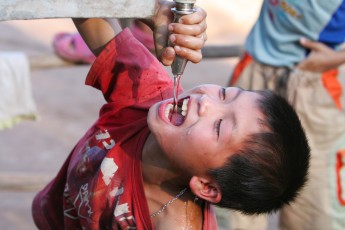 Boy gets water in Laos